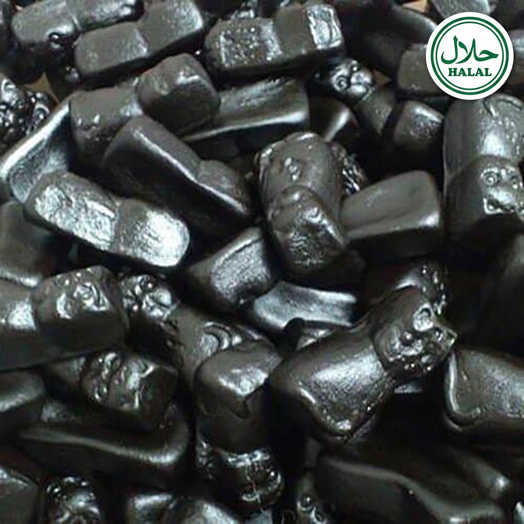 A close-up of small, bold black colored candy lollies with a textured surface.