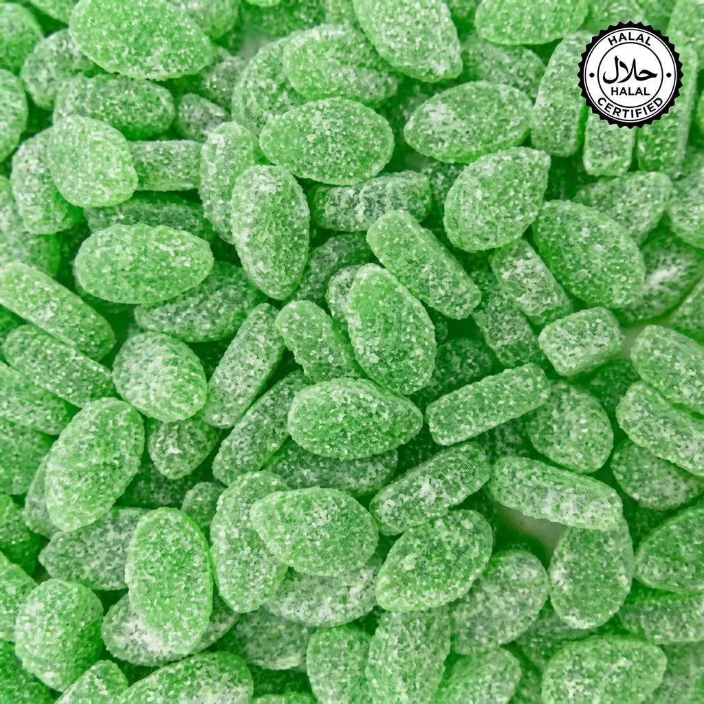 A close-up image of small, green mint candy pieces with a sugary coating.