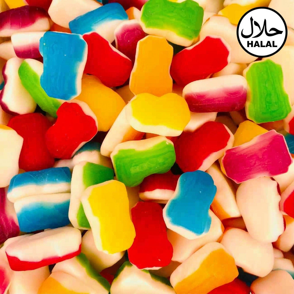A variety of colorful candies shaped like racing cars and other shapes, with a wide range of colors including red, yellow, green, blue, and pink.