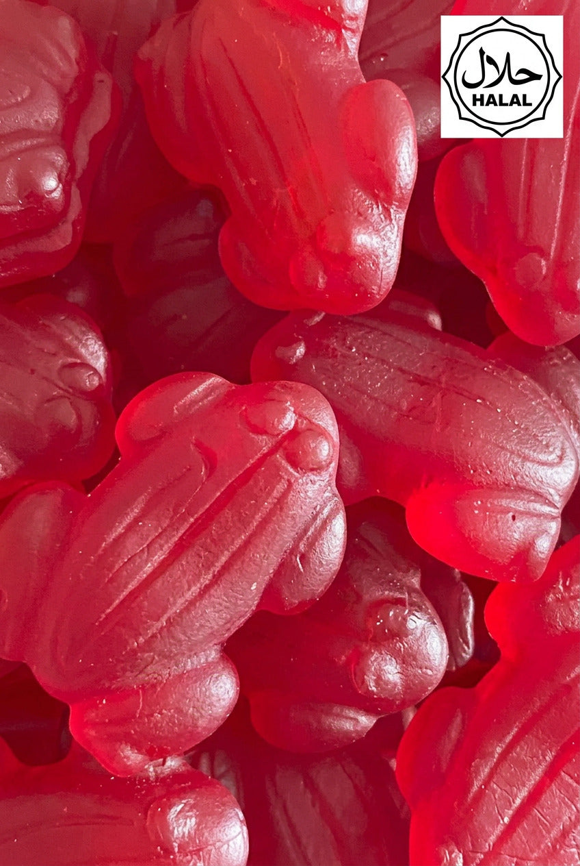 A close-up image of a group of red gummy candies shaped like frogs.